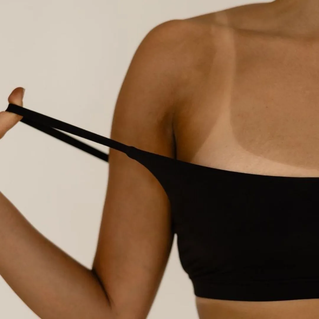 Close-up of woman stretching black bandeau strap