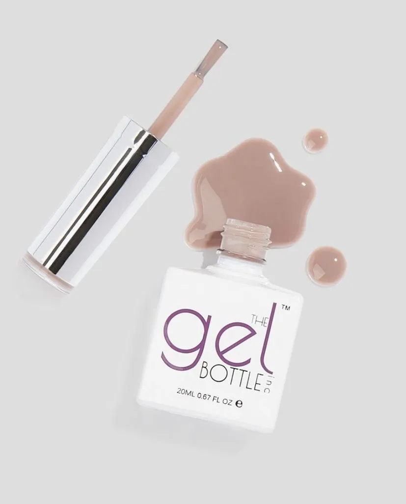 Open gel nail polish bottle with spill