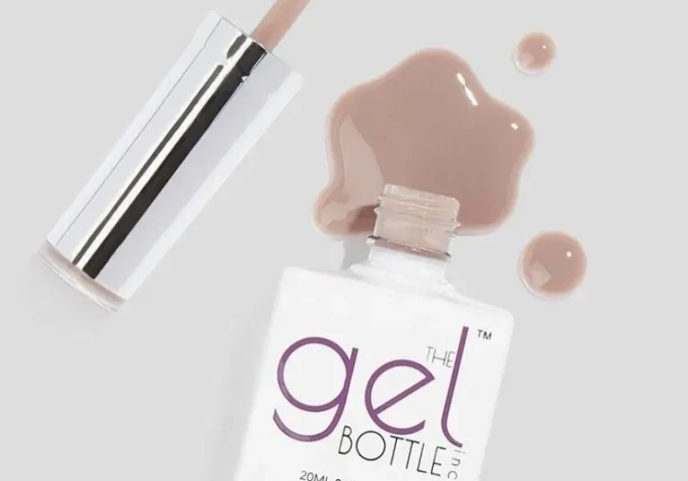 Open gel nail polish bottle with spill
